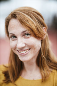 Smiling redhead woman with freckles