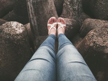 Low section of woman standing on rock