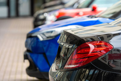 Close-up of the back of a row of cars parked at a business center