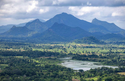 Scenic view of landscape and mountains against sky