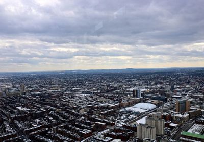 High angle view of city against cloudy sky