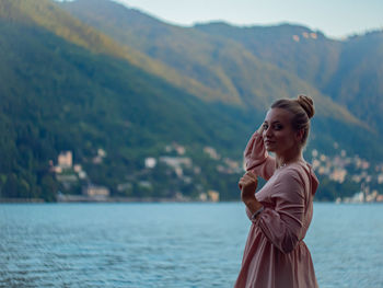 Portrait of young woman looking at mountain