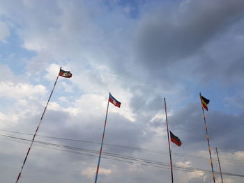 Low angle view of flag flags against sky