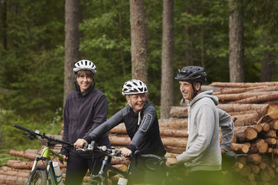 Friends cycling in forest