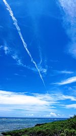 Low angle view of vapor trails in sky