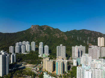 Cityscape against clear blue sky