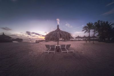 Scenic view of beach against sky during sunset