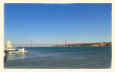 Bridge over river against clear sky