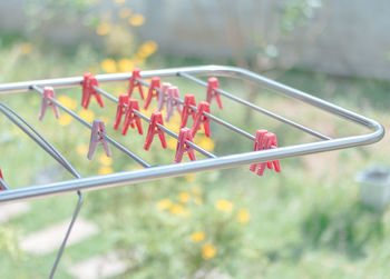 Close-up of clothespins on rack