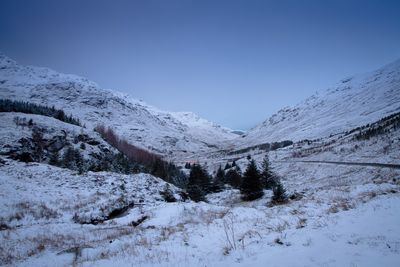 Scenic view of snow covered mountains against clear sky