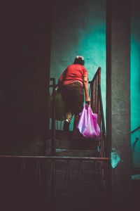 Full length of woman standing by railing