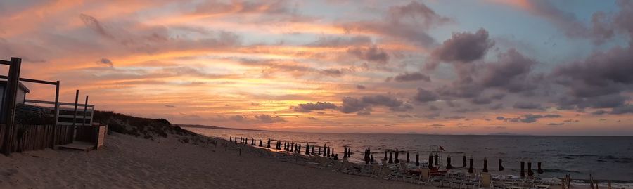 Scenic view of beach against sky during sunset