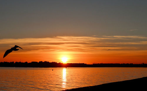 Scenic view of lake against sky during sunset