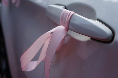 Close-up of pink bell hanging on floor