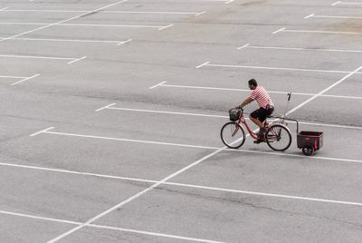 Rear view of man riding bicycle