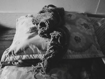 Close-up of dog relaxing on bed at home