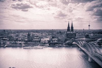 View of cityscape against cloudy sky