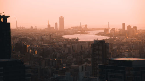 High angle view of buildings in city against sky during sunset