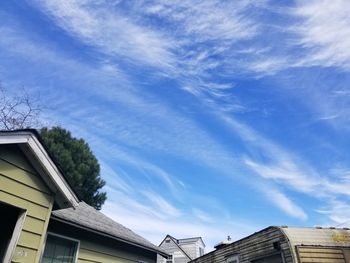 Low angle view of houses against blue sky