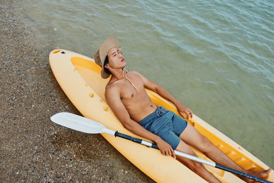 Rear view of woman sitting in sea