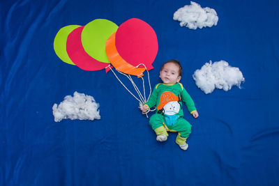 Full length of a boy holding balloons