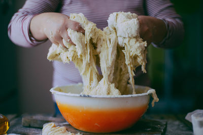 Close-up of hands kneading dough