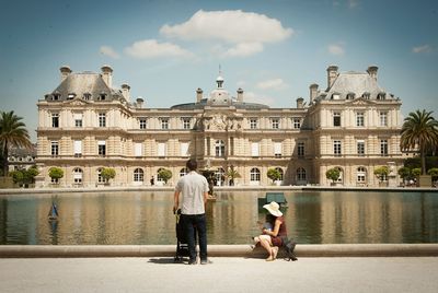 Full length of a man with woman in front of building