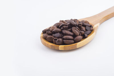 Close-up of coffee beans against white background