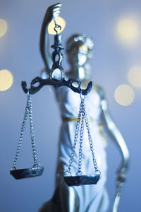 Close-up of lady justice against illuminated lights