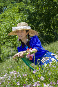 Woman wearing hat while standing on field