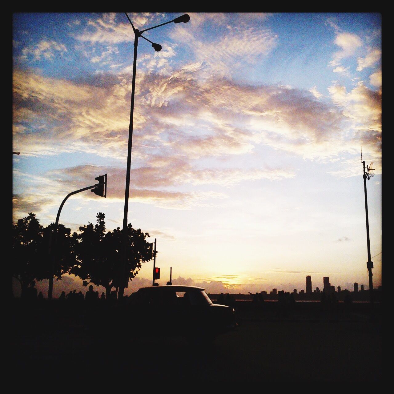 SILHOUETTE STREET AGAINST CLOUDY SKY