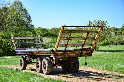 Abandoned truck on field against clear sky
