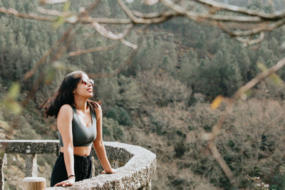 Young woman standing on rock