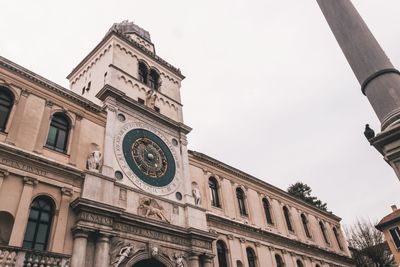 Low angle view of clock tower against sky