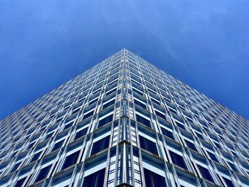 Low angle view of modern building against blue sky