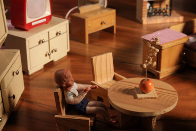 Boy sitting on table at home