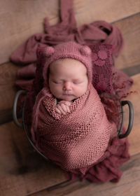 Portrait of cute baby boy lying on table