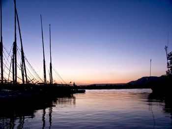 Sailboats in sea against sky during sunset