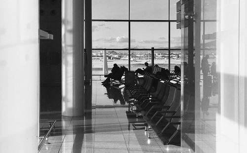 People at airport seen through glass window