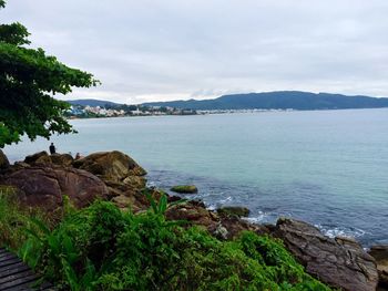 Scenic view of sea against cloudy sky