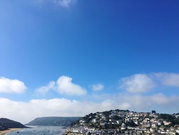 Aerial view of town against blue sky