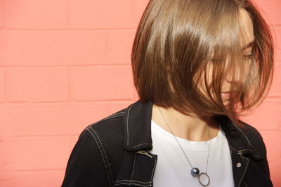 Portrait of woman against wall. hairs on the face