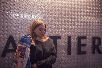 Young woman standing by text