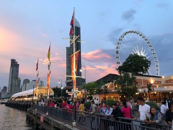 People in amusement park at dusk