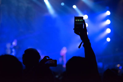 People photographing at music concert