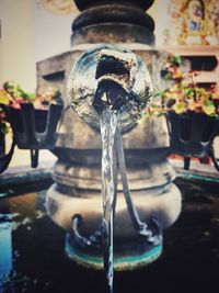 Close-up of water falling from faucet in fountain