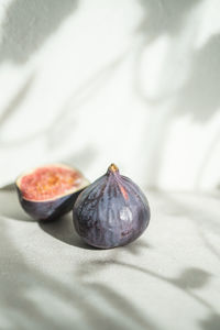 Close-up of figs on white table