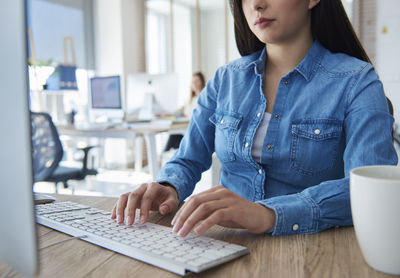 Midsection of woman working in office