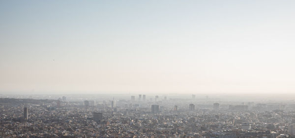 High angle view of city buildings against clear sky