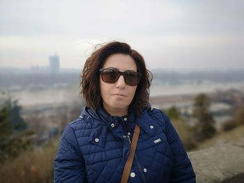 Portrait of woman wearing sunglasses against sky